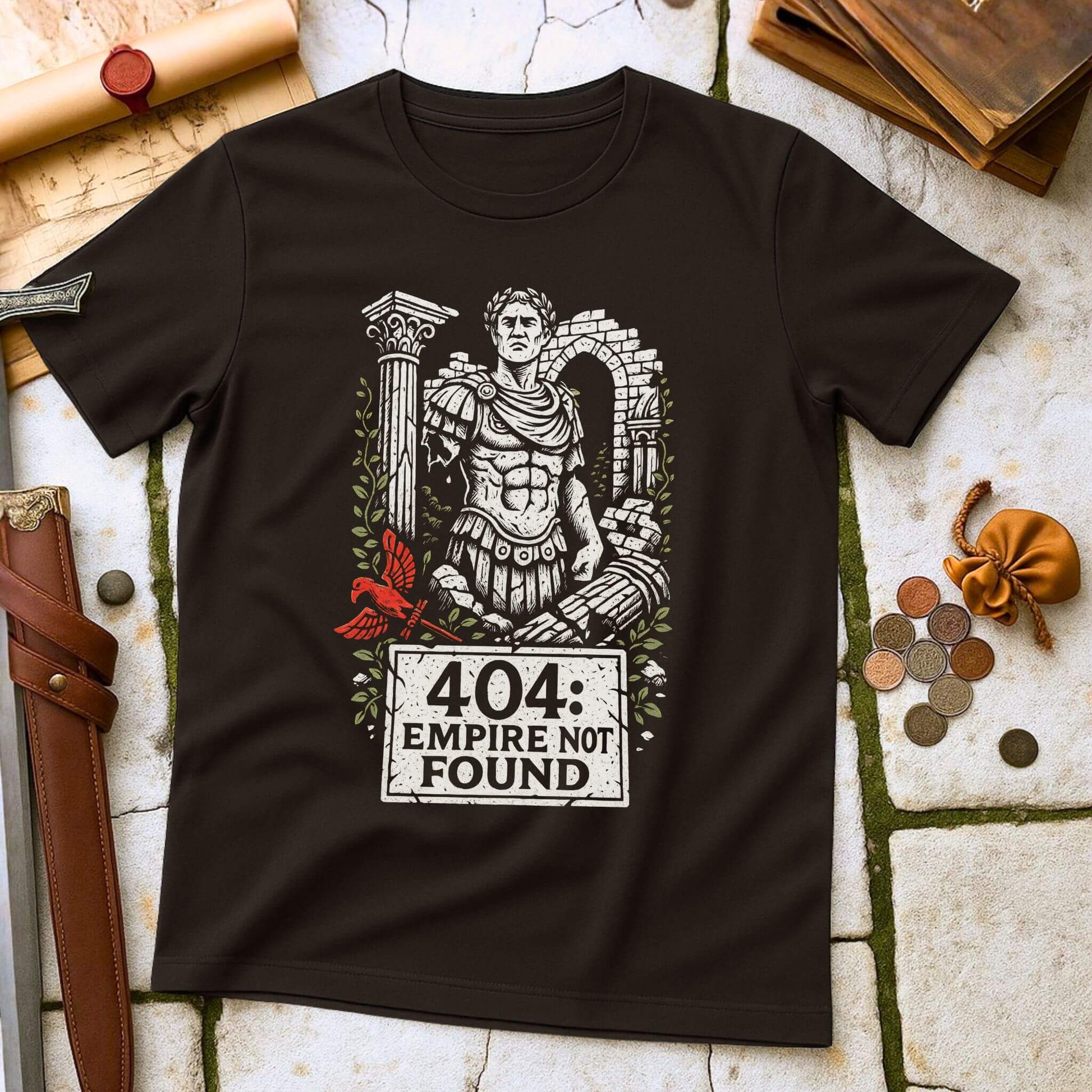 Black t-shirt with Roman emperor graphic and '404 Empire Not Found' text on a stone surface with coins and a belt.
