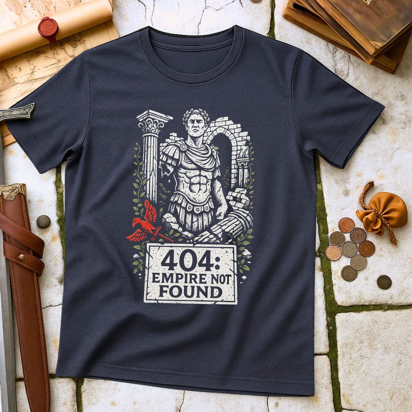 Navy blue t-shirt with Roman emperor graphic and '404 Empire Not Found' text on a stone surface with historical items.