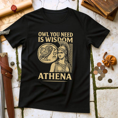Black t-shirt with Athena graphic and text on a stone surface with coins and books.