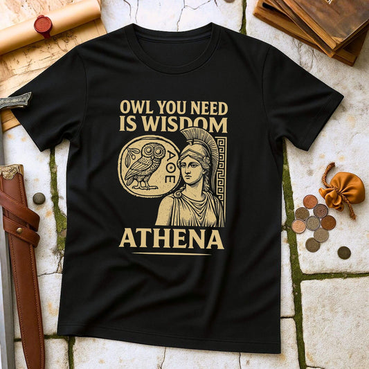 Black t-shirt with Athena graphic and text on a stone surface with coins and books.