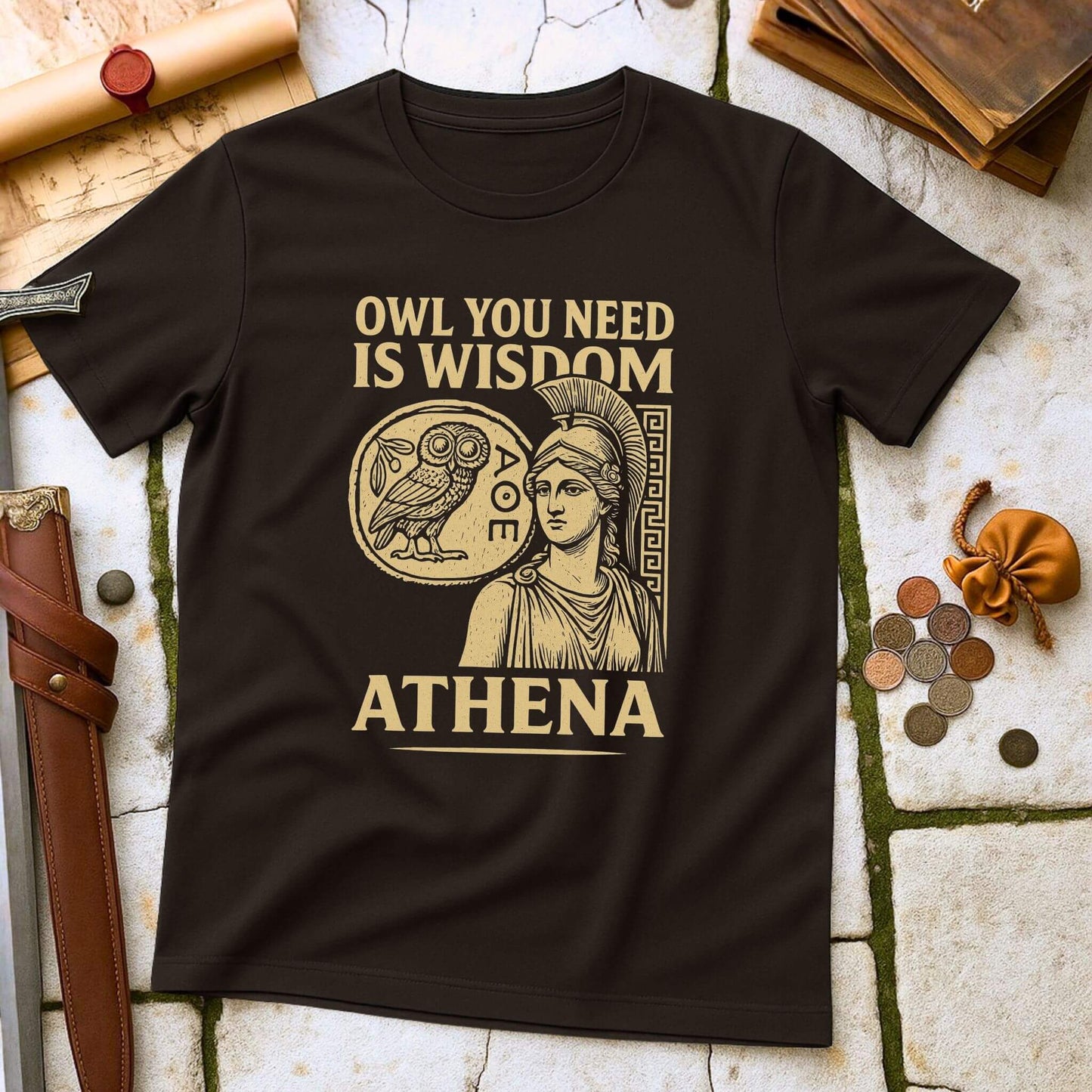 Dark Chocolate t-shirt with Athena graphic and text on a stone surface with coins and books.