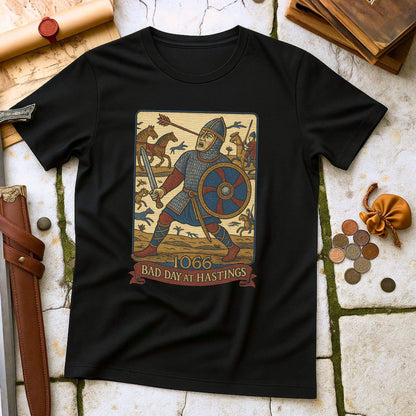 Black t-shirt with a graphic of a knight and text '1066 Bad Day at Hastings' on a stone surface.