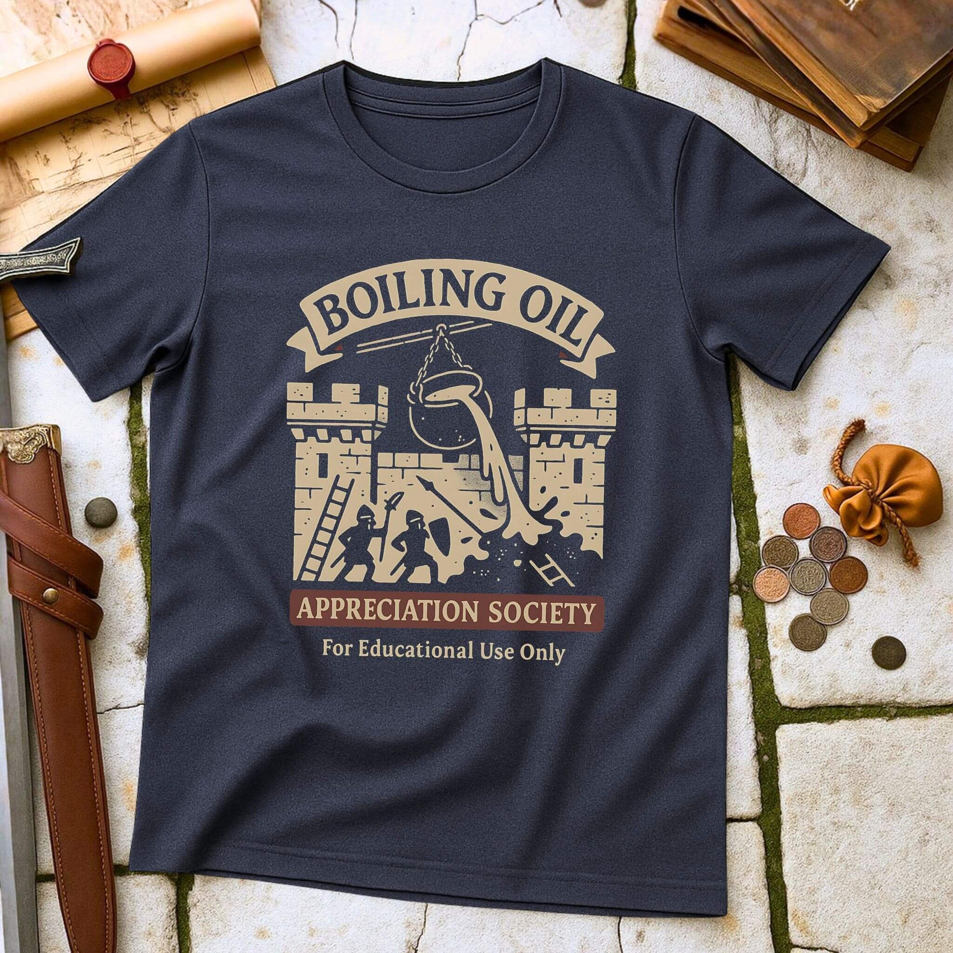 Heather Navy t-shirt with 'Boiling Oil Appreciation Society' graphic on a stone surface with historical props.