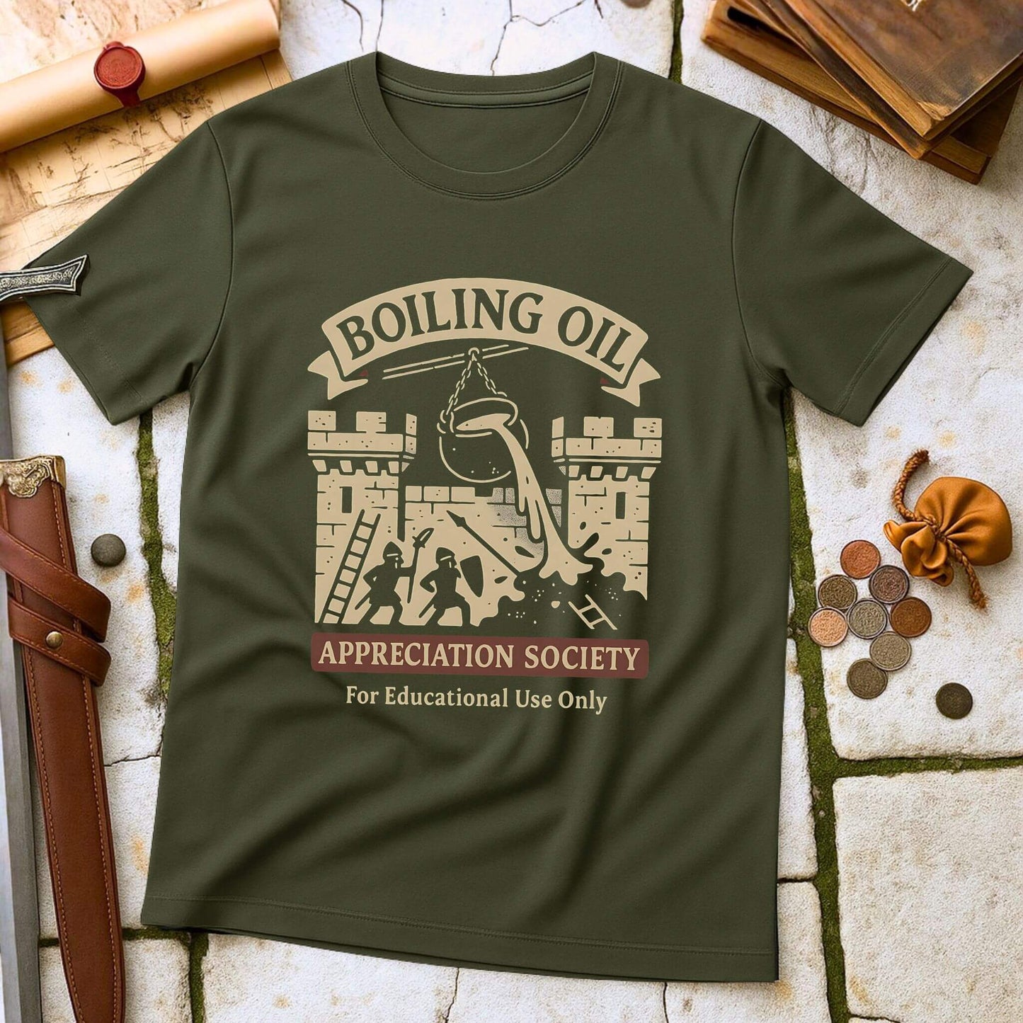 Military Green t-shirt with 'Boiling Oil Appreciation Society' graphic on a stone surface with historical props.