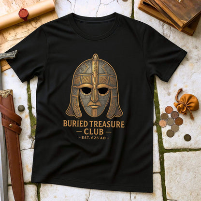 Black t-shirt with a Sutton Hoo helmet  graphic and 'Buried Treasure Club EST.625 AD' text on a stone surface