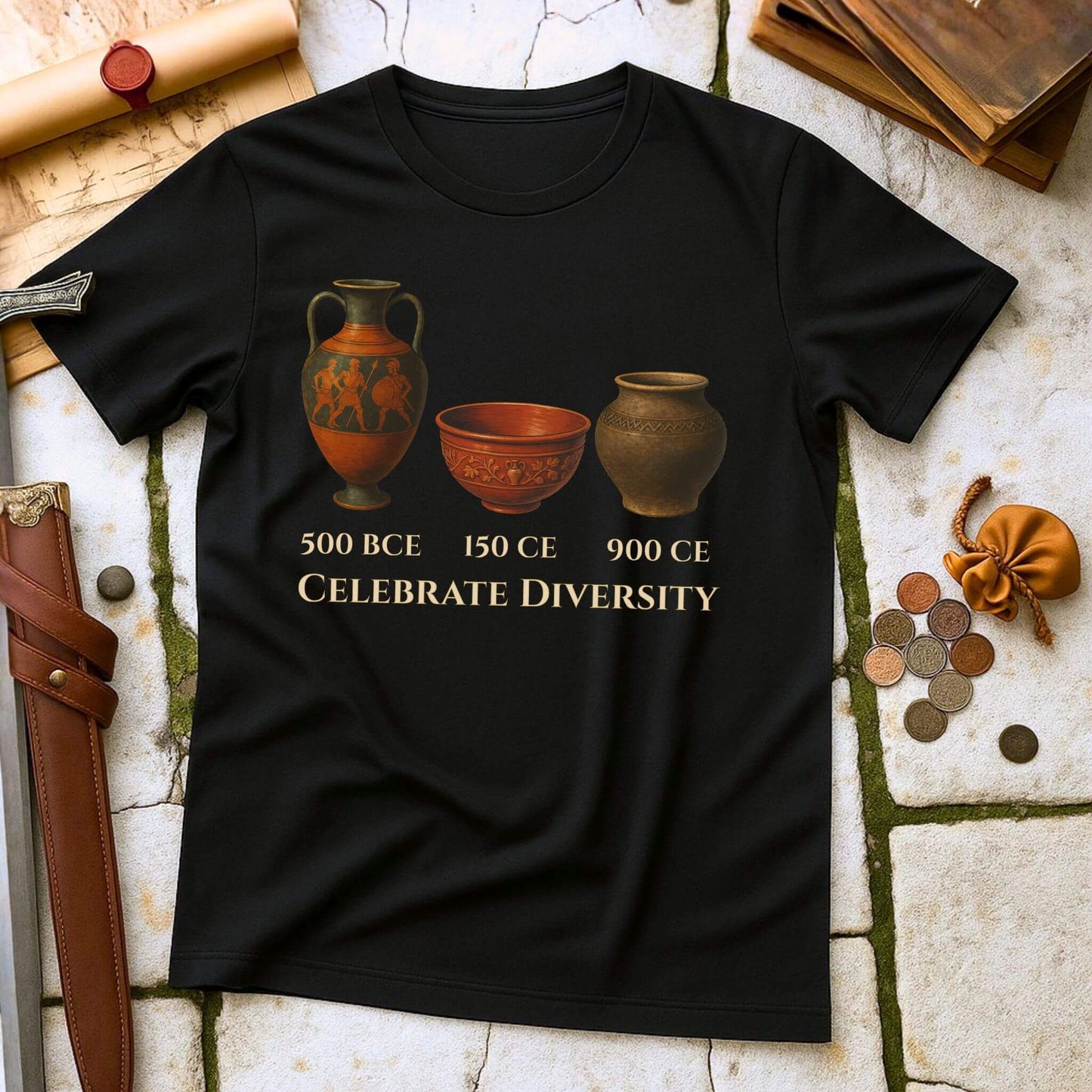 Black t-shirt with ancient pottery design and text on a stone surface with historical items.