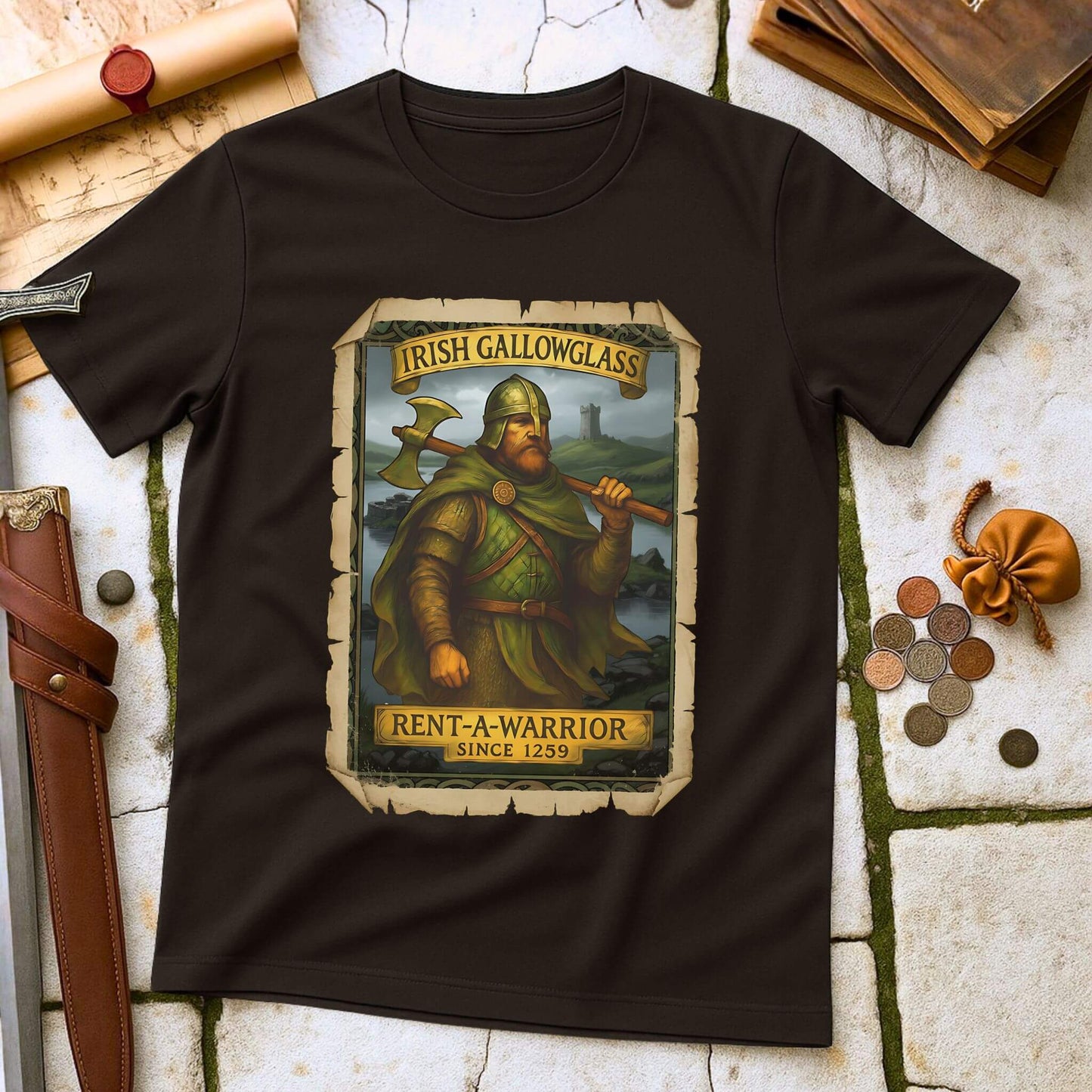Dark Chocolate t-shirt with a graphic of a Irish Gallowglass warrior and text on a stone surface with historical props. 