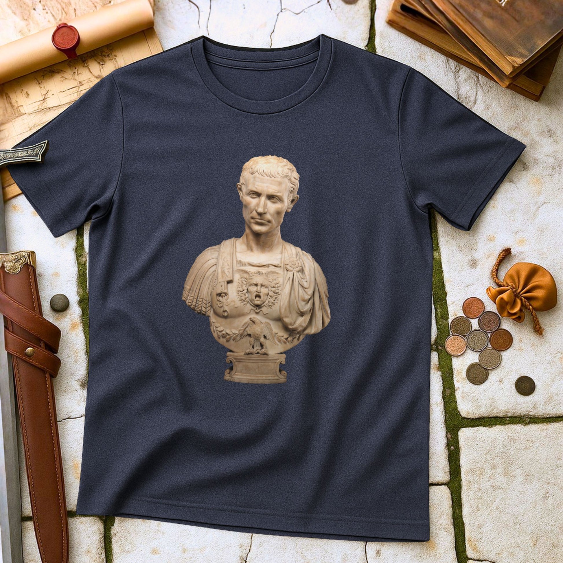 Julius Caesar Roman Emperor T-Shirt on a stone surface with historical items.