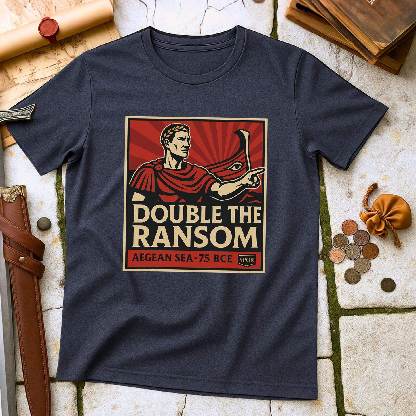 Navy blue t-shirt with 'Double the Ransom' graphic design on a stone surface with coins and a belt.