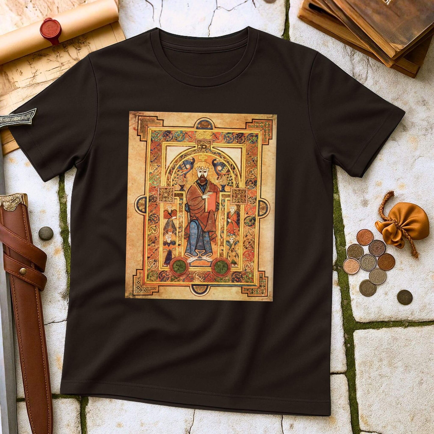 Manuscript T-Shirt Dark Chocolate with a decorative design of a figure in a frame on a textured surface.