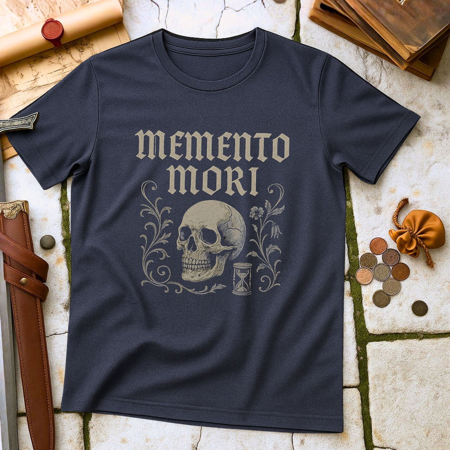 Black t-shirt with 'memento mori' design featuring a skull and hourglass on a textured surface.