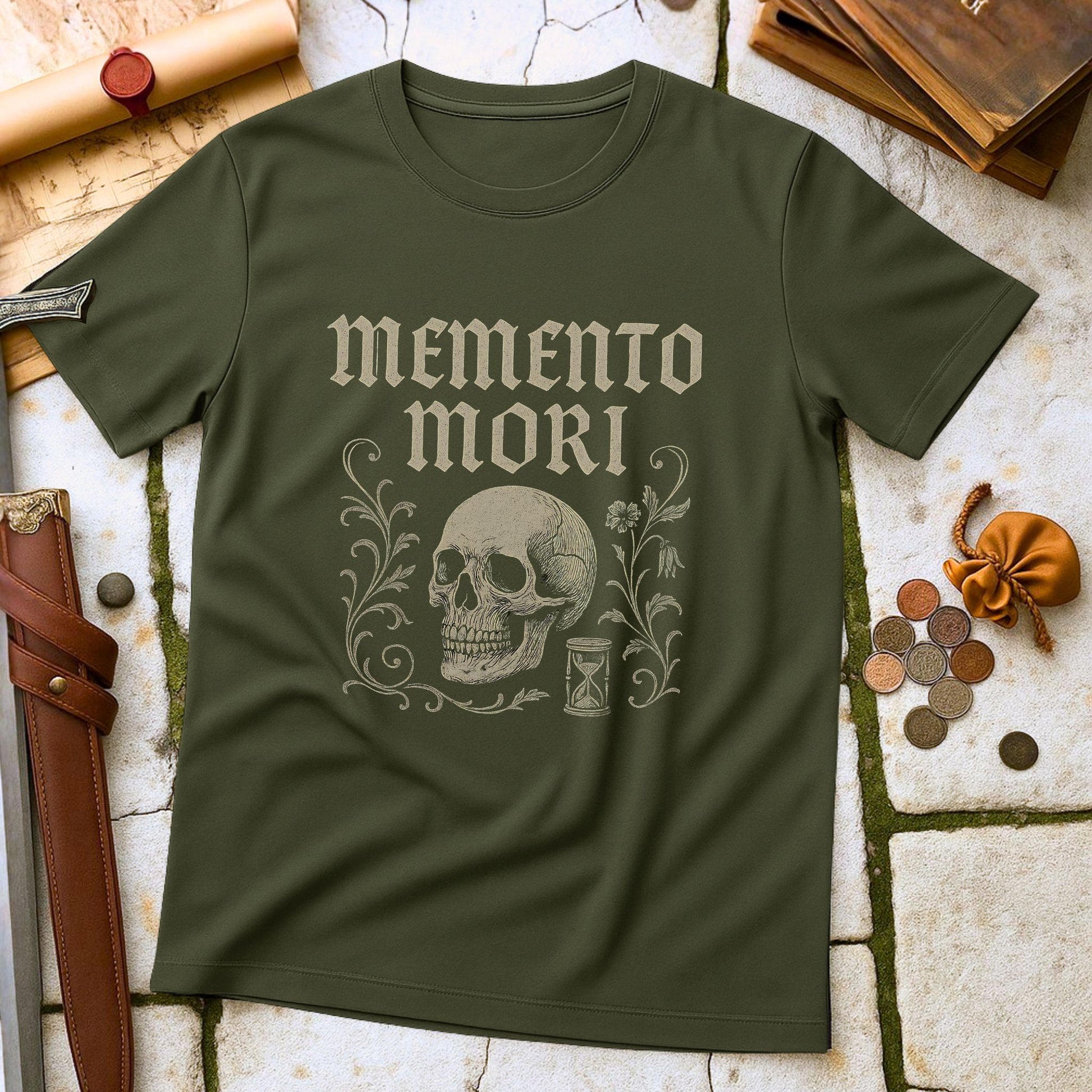 Green t-shirt with 'memento mori' design on a stone surface with historical items.