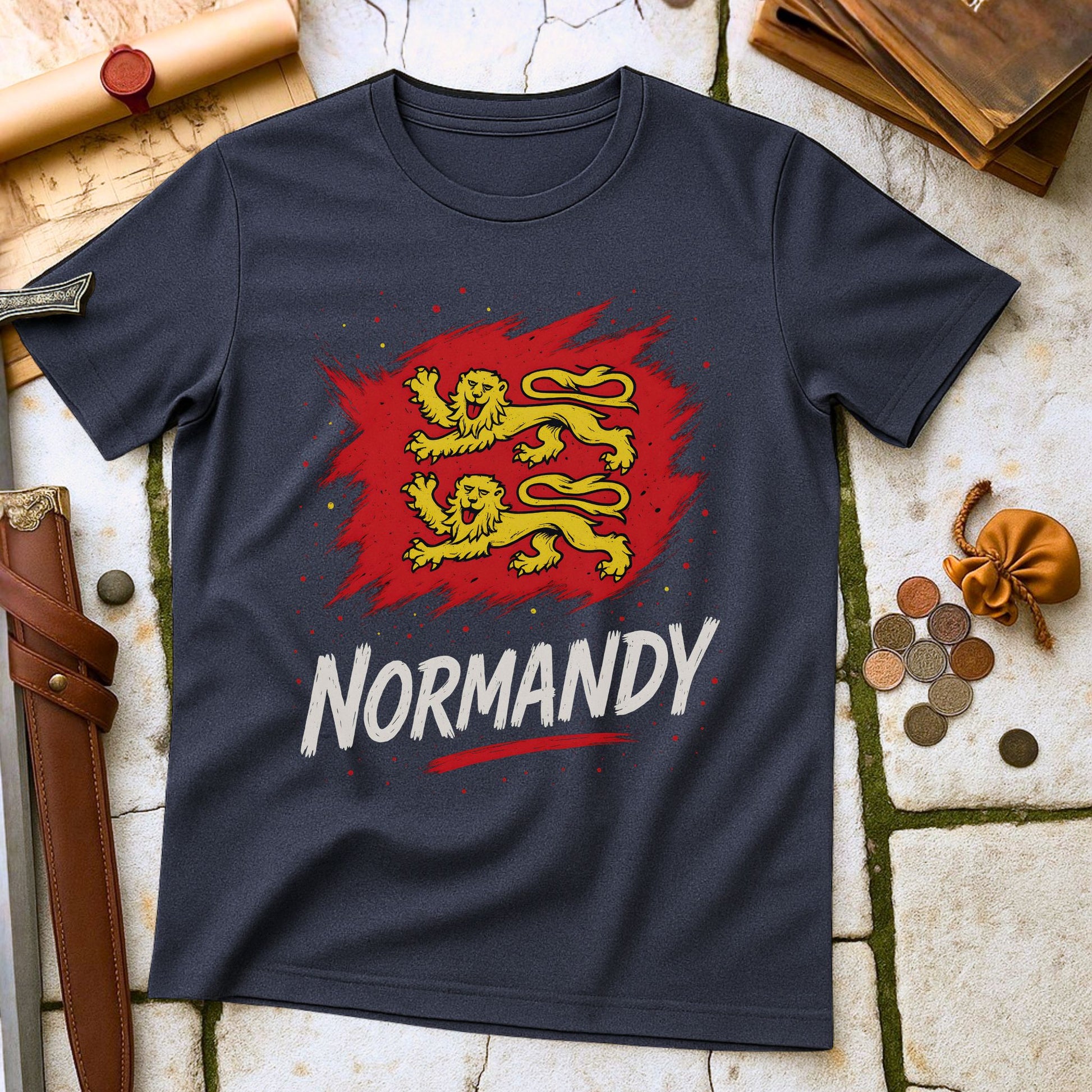 Heather Navy t-shirt with red and yellow lion design and 'Normandy' text on a stone surface with historical props.