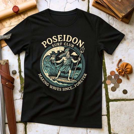 Black t-shirt with Poseidon Surf Club design on a textured surface with coins and a belt.