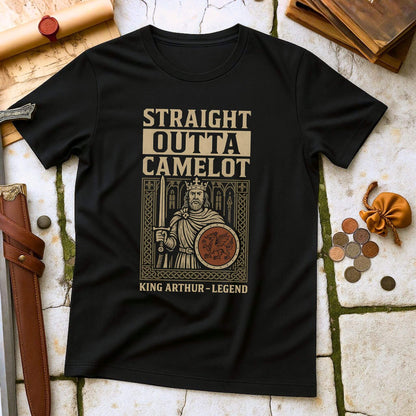 Black t-shirt with 'Straight Outta Camelot' graphic on a stone surface with props.