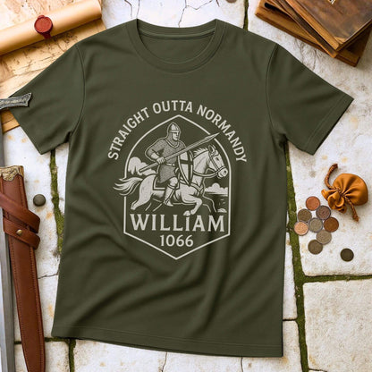 Military Green t-shirt with a graphic design of a knight with printed text that says " Straight outta Normandy WIlliam 1066"  on a stone surface with historical props.